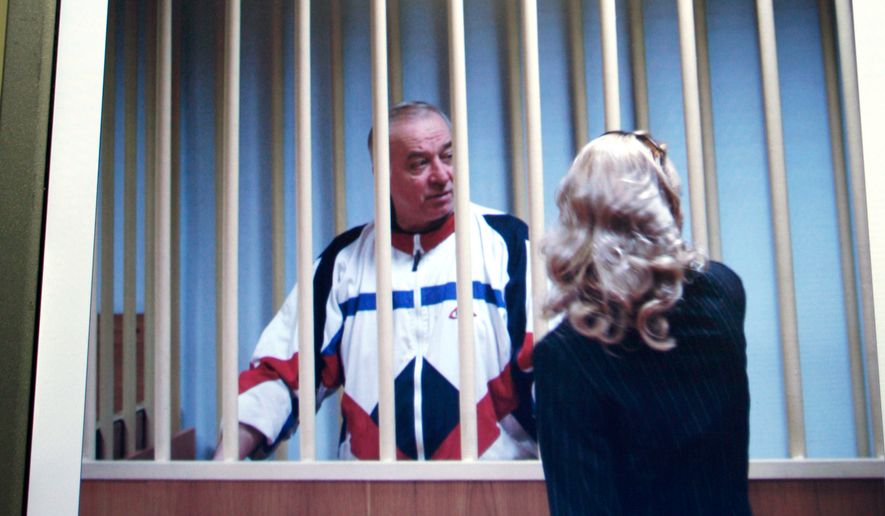 Sergei Skripal speaks to his lawyer from behind bars seen on a screen of a monitor outside a courtroom in Moscow on Wednesday, Aug. 9, 2006. Skripal a retired Russian colonel recruited by British intelligence in the mid-1990s was sentenced Wednesday by a military court in Moscow to 13 years imprisonment for spying, officials said. (AP Photo/Misha Japaridze)