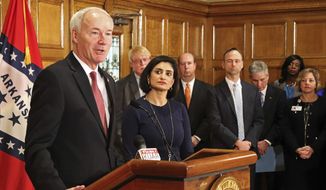 Gov. Asa Hutchinson speaks at a news conference Monday, March 5, 2018, at the state Capitol in Little Rock, Ark., with Seema Verma, the head of the Centers for Medicare and Medicaid Services. Verma on Monday approved a state plan to require that thousands of people on its Medicaid expansion seek ways to work or volunteer. Traditional Medicaid recipients are not affected. Arkansas is the third state to win permission, following Kentucky and Indiana. (AP Photo/Kelly P. Kissel)