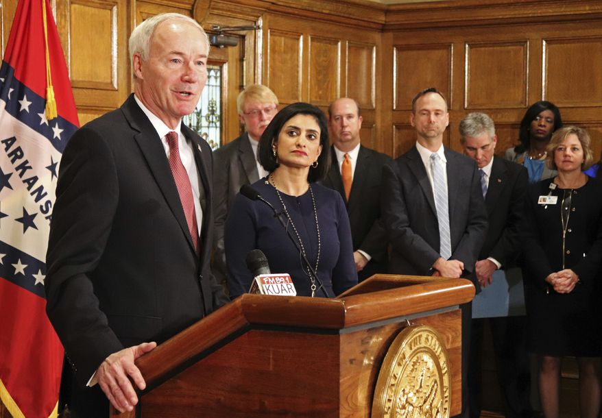 Gov. Asa Hutchinson speaks at a news conference Monday, March 5, 2018, at the state Capitol in Little Rock, Ark., with Seema Verma, the head of the Centers for Medicare and Medicaid Services. Verma on Monday approved a state plan to require that thousands of people on its Medicaid expansion seek ways to work or volunteer. Traditional Medicaid recipients are not affected. Arkansas is the third state to win permission, following Kentucky and Indiana. (AP Photo/Kelly P. Kissel)