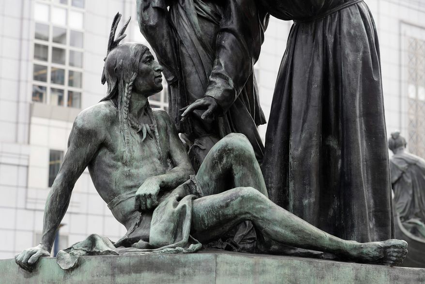 A statue of a Native American below Sir Francis Drake and Father Junipero Serra in San Francisco. San Francisco's arts commission is considering removing a statue that some say is degrading to Native Americans. The city's arts commission is scheduled to discuss the sculpture Monday and has the final say on its fate. (AP Photo/Jeff Chiu)