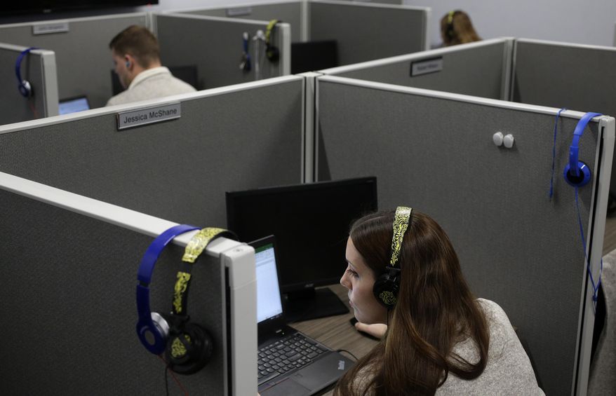 In this Nov. 8, 2017, photo, Jessica McShane, an employee at Interactions Corp., foreground, monitors person-to-computer communications, helping computers understand what a human is saying, in the "intent analysis" room at the company's headquarters in Franklin, Mass. “That information is used to feedback into the system using machine learning to improve our model,” said Robert Nagle, Interactions’ chief technology officer. “Next time through, we’ve got a better chance of being successful.” (AP Photo/Steven Senne)