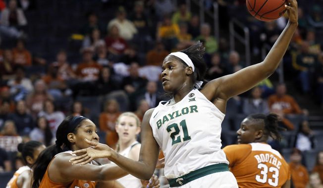 Baylor center Kalani Brown (21) grabs an inbound pass in front of Texas forward Jatarie White (40) in the first half of an NCAA college basketball game in the championship game of the women&#x27;s Big 12 conference tournament in Oklahoma City, Monday, March 5, 2018. (AP Photo/Sue Ogrocki)