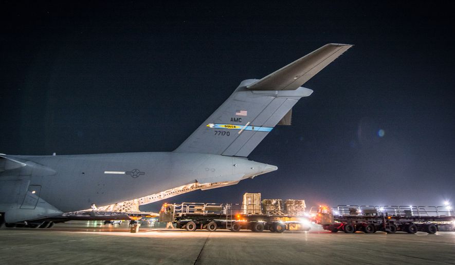 Crews offload equipment from a C-17 Globemaster III assigned to the 816th Expeditionary Airlift Squadron, at Bagram Airfield, Jan. 25, 2018. The C-17 transported troops and equipment to forward operating locations throughout the U.S. Central Command area of responsibility in support of Operation Freedom’s Sentinel and NATO Resolute Support missions. The C-17 is not only proficient in transporting troops and cargo, but can perform tactical airlift and airdrop missions and transport ambulatory patients during aeromedical evacuations. (U.S. Air National Guard photo by Staff Sgt. Patrick Evenson)