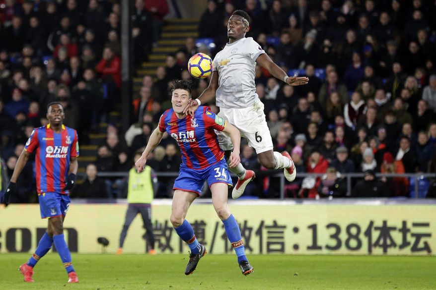 Manchester United's Paul Pogba, right, competes for the ball with Crystal Palace's Martin Kelly during the English Premier League soccer match between Crystal Palace and Manchester United at Selhurst Park in London, Monday, March 5, 2018. (AP Photo/Tim Ireland)