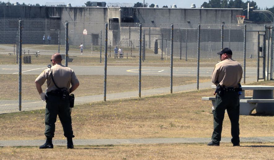 In this Aug. 17, 2011 file photo, correctional officers keep watch on inmates in the recreation yard at Pelican Bay State Prison near Crescent City, Calif. (AP Photo/Rich Pedroncelli, File) **FILE**