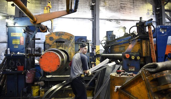 In this Feb. 20, 2018, photo, slitter operator Dylan McCone of Philadelphia works inside Camden Yards Steel in Camden, N.J. The company makes an effort to hire workers from within the city, offering job training and sometimes even a trip to the bank to help open a checking account. (Joe Lamberti/Camden Courier-Post via AP)