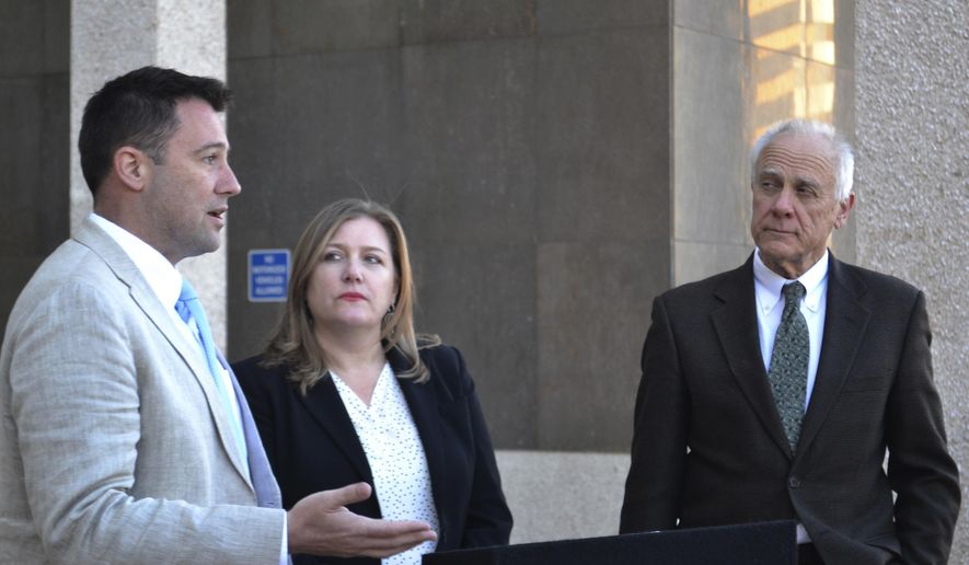 Albuquerque City Councilor Pat Davis, left, discusses a proposal to decriminalize possessing an ounce of marijuana or less with Emily Kaltenbach, of the Drug Policy Alliance, center, and fellow Councilman Isaac Benton, right, at a news conference in Albuquerque, N.M., Monday, March 5, 2018. Davis and Benton's proposed change to the local criminal code would add Albuquerque to a growing list of municipalities that have decriminalized possessing pot in small amounts. (AP Photo/Mary Hudetz).