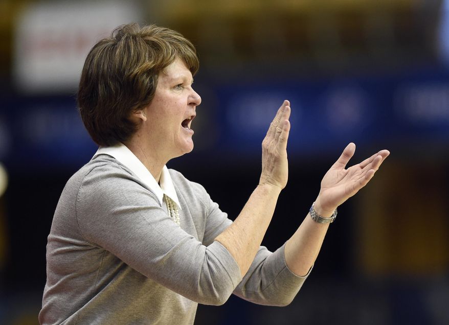 Mercer head coach Susie Gardner cheers on her team in the second half of an NCAA college basketball game against East Tennessee State in the Southern Conference tournament championship on Sunday, March 4, 2018, in Asheville, N.C. (AP Photo/Kathy Kmonicek)