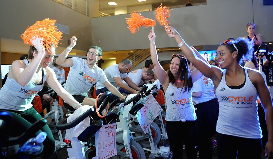 Participants in the annual Cycle for Survival fundraiser on March 2 wave pom-poms at the event at Equinox Sports Club in the District The national charity has raised over $170 million in 12 years for rare cancer research. (Courtesy of Cycle for Survival)