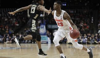 Syracuse guard Frank Howard (23) drives past Wake Forest guard Bryant Crawford (13) during the second half of an NCAA college basketball game in the Atlantic Coast Conference men&#x27;s tournament Tuesday, March 6, 2018, in New York. Syracuse won 73-64. (AP Photo/Julie Jacobson)
