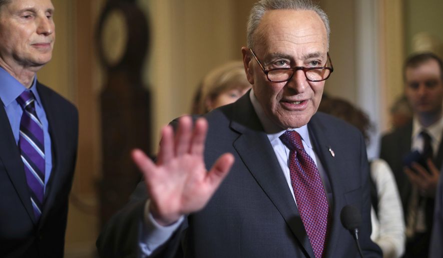 Senate Minority Leader Chuck Schumer of N.Y., right, speaks to reporters following weekly policy luncheons to answer questions on Capitol Hill in Washington, Tuesday, March 6, 2018. Watching is Sen. Ron Wyden, D-Ore., left. The Senate moves closer to passing legislation to roll back some of the safeguards Congress put in place to prevent a repeat of the 2008 financial crisis. (AP Photo/Pablo Martinez Monsivais)