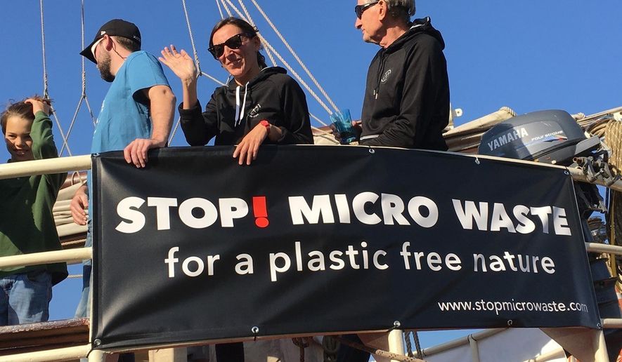 In this Oct. 15, 2017, photo provided by Alexander Nolte, Marta Delgado, center, and Joseph Dillard, right, participate in an event to raise awareness about microfiber pollution in the environment in Amsterdam, Netherlands. Innovators are coming up with new tools to prevent tiny pieces of threads from entering waterways after the laundry and reaching marine life. (Alexander Nolte via AP)