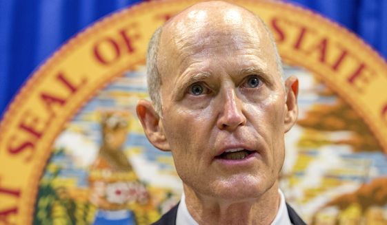 Florida Gov. Rick Scott lays out his school safety proposal during a press conference at the Florida Capitol in Tallahassee, Fla., Friday, Feb 23, 2018. Scott proposed banning the sale of firearms to anyone younger than 21 as part of a plan to prevent gun violence. (AP Photo/Mark Wallheiser) ** FILE **