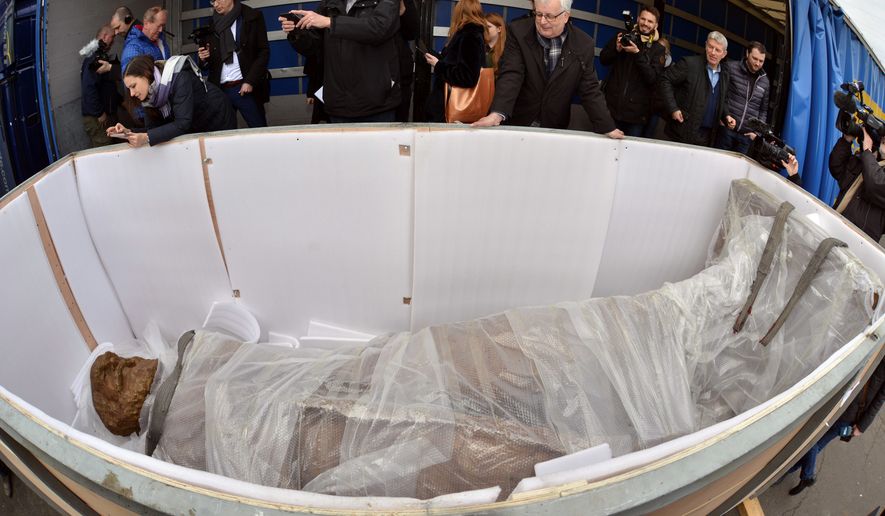 A statue of Karl Marx lies in a transport box as it arrived in Trier, Germany, Tuesday, March 6, 2018. A larger-than-life statue of Karl Marx has arrived in his hometown of Trier, in western Germany. The bronze sculpture, donated by China, is to be unveiled in May to mark the 200th anniversary of Marxs birthday.  (Harald Tittel/dpa via AP)