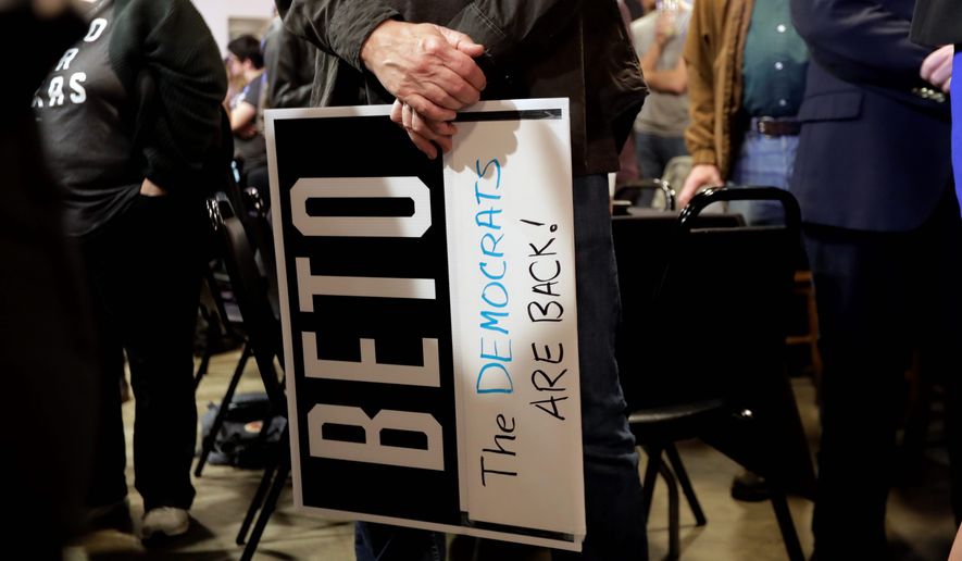 A supporter of Senate hopeful Beto O&#39;Rourke holds a sign during a Democratic watch party following the Texas primary election, Tuesday, March 6, 2018, in Austin, Texas. (AP Photo/Eric Gay)