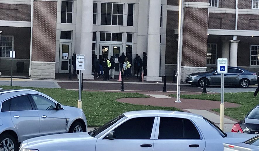 Authorities investigate the scene where a shooting occurred at Huffman High School, Wednesday, March 7, 2018, in Birmingham, Ala. Birmingham Interim Police Chief Orlando Wilson said at a news conference that authorities are seeking to determine whether the shooting Wednesday at the Alabama high school was accidental or if a gun since recovered by investigators was intentionally discharged. (Carol Robinson/AL.com via AP)