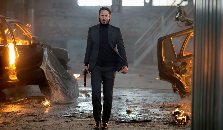 Keanu Reeves carries a firearm in a dramatic scene of &quot;John Wick.&quot; (Associated Press/File)