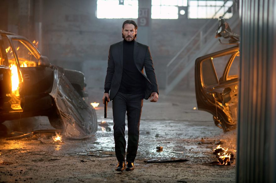 Keanu Reeves carries a firearm in a dramatic scene of &quot;John Wick.&quot; (Associated Press/File)