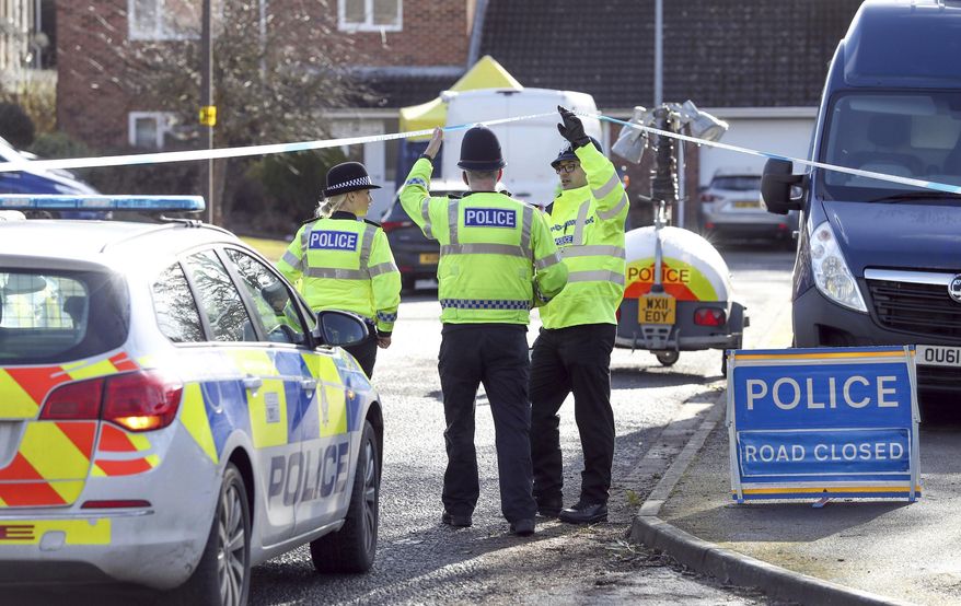 Police officers seal off a cul-de-sac in Salisbury, England, near to the home of former Russian ex-spy Sergei Skripal as a nerve agent is believed to have been used to critically injure him and his daughter Yulia. Britain's Home Secretary says the investigation into the nerve agent attack on a Russian ex-spy and his daughter is focusing on three sites — his home, a pub and a restaurant. (Andrew Matthews/PA via AP)