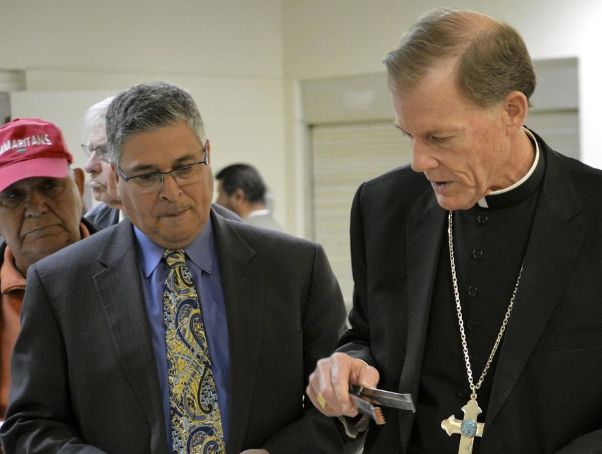 FILE - In this Feb. 24, 2016 file photo, New Mexico Conference of Catholic Bishops executive director Allen Sanchez, left, and Santa Fe Archbishop John Wester talk before the start of an immigration forum at Our Lady of Guadalupe parish in Albuquerque, N.M. New Mexico's three Catholic bishops said the head of the New Mexico Conference of Catholic Bishops didn't accuse anyone of racism and are defending his actions in trying to push for an expansion of early childhood education programs. In an open letter Tuesday, March 6, 2018, the bishops wrote that Allen Sanchez, executive director of the group, has a deep love "for the Gospel" and is an advocate for the state's poor with an extension record. (AP Photo/Russell Contreras, File)