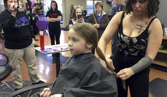 In this Feb. 5, 2018 photo, Montana Schmidt, right, a stylist at Kevin &amp;amp; Co. cuts the hair of  Sophia Wright at the salon in Danville. Ill., as part of Sophia&#39;s donation to Pantene&#39;s Beautiful Lengths program, which provides free wigs to cancer patients. Sophia inspired at least eight other children and adults to make a hair donation. (Noelle McGee/The News-Gazette via AP )