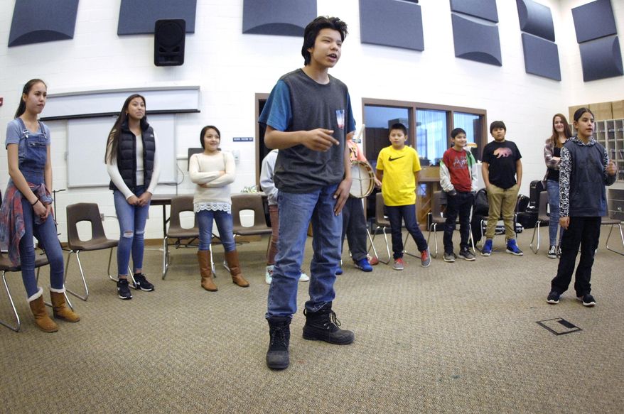 Helixo Eagle, left, and Zaniyan Iron Eyes, far right, perform a rap duet with other students from Standing Rock Middle and Elementary School while rehearsing the original song "Somebody" at the Fort Yates school on Wednesday, March 7, 2018 in Fort Yates, N.D. The group of 11 students will perform this weekend in Washington, D.C. as part of a talent show organized by the Turnaround Arts Initiative program. (Mike McCleary/The Bismarck Tribune via AP)