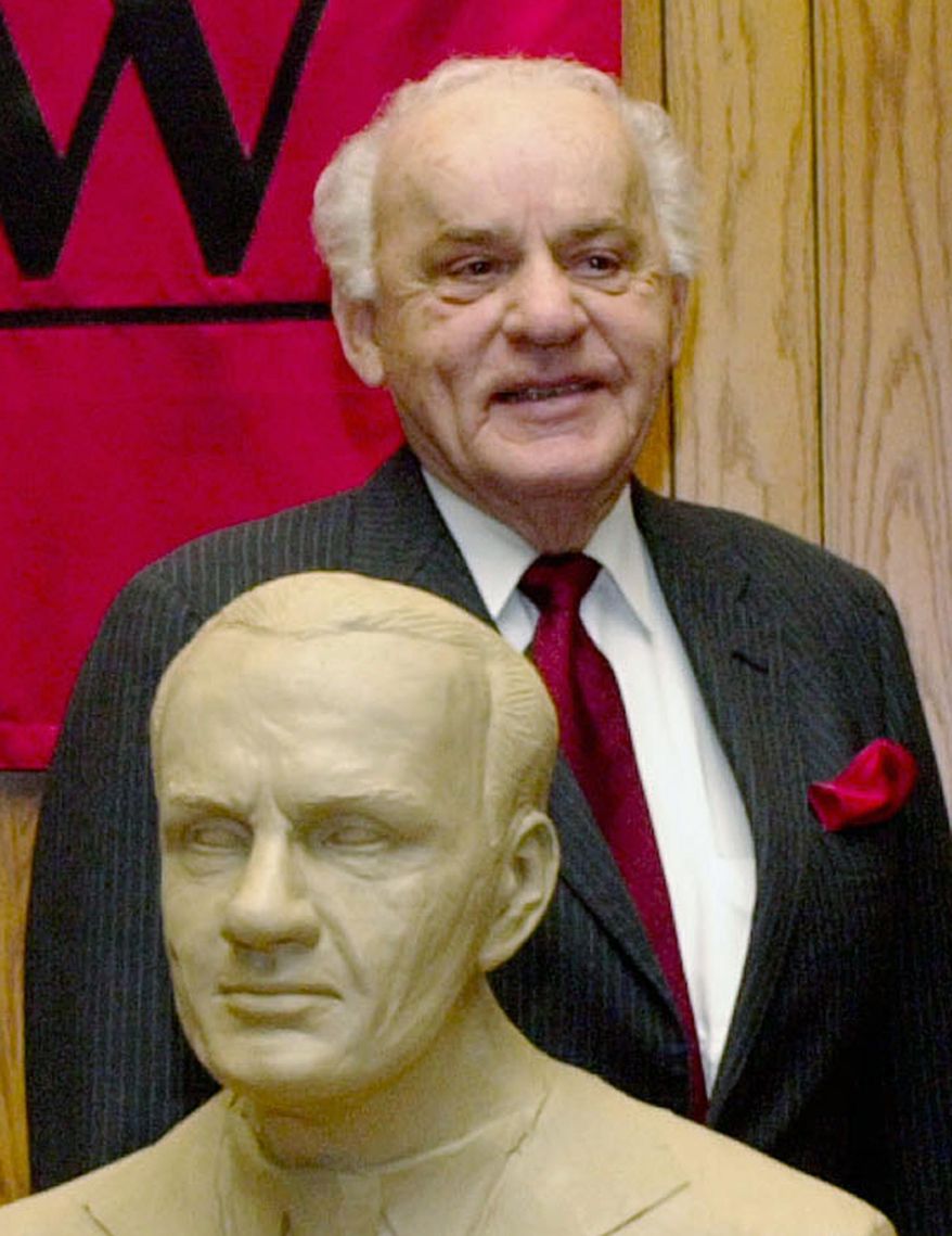 FILE - In this Feb. 22, 2003 file photo, former Neb. Governor, Charles Thone stands behind his clay bust in Lincoln, Neb., as the University of Nebraska-Lincoln College of Law paid tribute to five alumni governors. Thone, a former Nebraska governor and congressman who helped investigate the assassinations of President John F. Kennedy and Martin Luther King Jr., has died. He was 94. Thone's law partner and longtime friend, Mark Schorr, said Thone died Wednesday, March 7, 2018, of natural causes at his home in Lincoln. (AP Photo/Nati Harnik File)