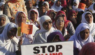 A Pakistani acid attack victim, center, takes part in a rally to mark International Women&#x27;s Day in Karachi, Pakistan, Thursday, March 8, 2018. (AP Photo/Fareed Khan)