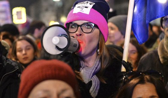 Protesters take part in a Women&#39;s Day march in Warsaw, Poland, Thursday, March 8, 2018. A few thousand women and men chanting women&#39;s rights slogans marched through  central Warsaw to mark the International Women&#39;s Day. (AP Photo/Alik Keplicz)