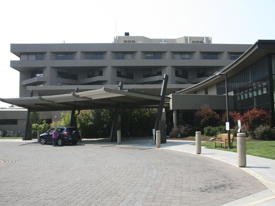 This 2014 photo shows the main entrance to St. Charles hospital in Bend, Ore. Officials from the Bend hospital say a sewage leak led them to cancel some surgeries and left patients without water to shower or use toilets for several hours. The Bulletin reports hospital staff discovered the leak Tuesday morning, March 6, 2018, in the central processing department where surgical instruments are cleaned and sterilized. (Andy Tullis/The Bulletin via AP)