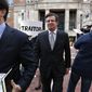 Jason Maloni, left, former Trump campaign chairman Paul Manafort&#x27;s spokesman, left, walks with Paul Manafort, center, as they leave the Alexandria Federal Courthouse after an arraignment hearing on his Eastern District of Virginia charges, in Alexandria, Va., Thursday, March 8, 2018. Behind Manafort protester Bill Christeson holds up a sign that says &amp;quot;traitor.&amp;quot; (AP Photo/Jacquelyn Martin)