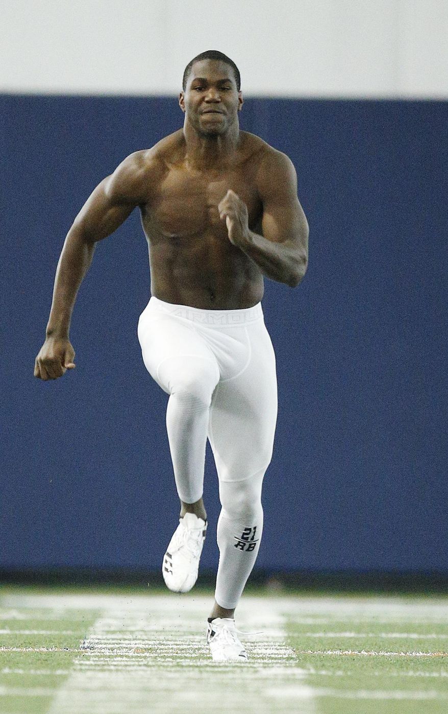 Auburn running back Kerryon Johnson runs the 40-yard dash during Auburn's Pro Day, Friday, March 9, 2018, in Auburn, Ala. The event is to showcase players for the upcoming NFL football draft. (AP Photo/Brynn Anderson)