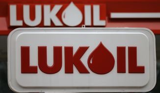 FILE - In this Oct. 18, 2006 file photo, a Lukoil gas station is seen in Philadelphia. A lawsuit has been filed in Florida on Thursday, March 8, 2018, against Glencore, Lukoil and other international energy firms for their alleged role funneling bribes to corrupt Venezuelan officials in exchange for rigged oil purchase contracts involving state-run PDVSA. (AP Photo/Matt Rourke, File)