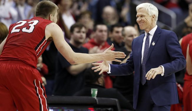 Davidson head coach Bob McKillop, right, greets forward Peyton Aldridge (23) as he leaves the game late in the second half of an NCAA college basketball game against St. Bonaventure at the Atlantic 10 Conference tournament, Saturday, March 10, 2018, in Washington. Davidson won 82-70. (AP Photo/Alex Brandon)