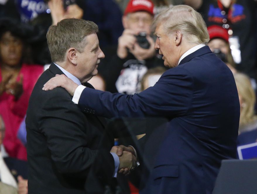 President Donald Trump, right, talks with Republican Rick Saccone during a campaign rally, Saturday, March 10, 2018, in Moon Township, Pa. Saccone is running against Democrat Conor Lamb in a special election being held on March 13 for the Pennsylvania 18th Congressional District vacated by Republican Tim Murphy. (AP Photo/Keith Srakocic)