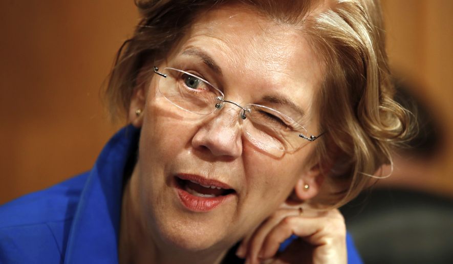 Sen. Elizabeth Warren, D-Mass., winks as she jokes with other senators on the Senate Banking Committee ahead of a hearing on the nomination of Marvin Goodfriend to be a member of the Federal Reserve Board of Governors, Tuesday, Jan. 23, 2018, on Capitol Hill in Washington. (AP Photo/Jacquelyn Martin)