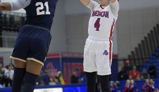 American guard Emily Kinneston (4) shoots against Navy guard Jasmine Bishop (21) during the first half an NCAA college basketball game for the Patriot League women&#x27;s tournament championship, Sunday, March 11, 2018, in Washington. (AP Photo/Nick Wass)