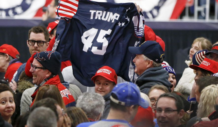 Supporters wave a jersey supporting President Donald Trump before he arrives for a campaign rally for Republican Rick Saccone, Saturday, March 10, 2018, in Moon Township, Pa. Saccone is running against Democrat Conor Lamb in a special election being held on March 13 for the Pennsylvania 18th Congressional District vacated by Republican Tim Murphy. (AP Photo/Keith Srakocic)