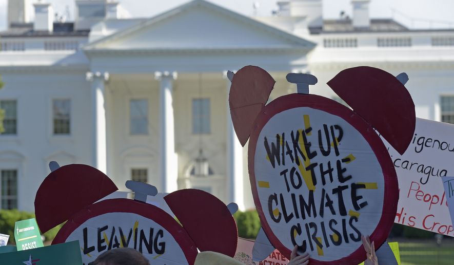 Protesters gather outside the White House in Washington, Thursday, June 1, 2017, to protest President Donald Trump&#x27;s decision to withdraw the Unites States from the Paris climate change accord. (AP Photo/Susan Walsh)