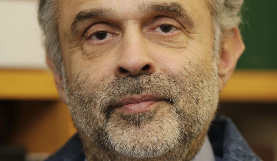 FILE - This Feb. 5, 2009, file photo shows Joaquin Avila, in his office in Seattle. Avila, who for years fought discrimination in the classroom, the work place and the voting booth with groundbreaking success, died Friday, March 9, 2018, according to the Mexican American Legal Defense and Educational Fund. He was 69. (AP Photo/Ted S. Warren, File)
