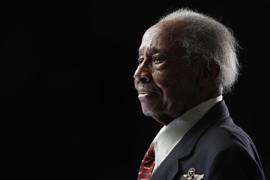 FILE - In this Jan. 10, 2012 file photo, Tuskegee Airman Floyd Carter Sr. poses for a portrait during a news conference in New York for the film "Red Tails," chronicling the heroism of the Tuskegee Airmen during WWII. The New York Police Department says Carter Sr. died on March 8, 2018, at the age of 95. In addition to his service with the fabled Tuskegee Airmen, Carter spent 27 years with the NYPD. (AP Photo/Carlo Allegri, File)