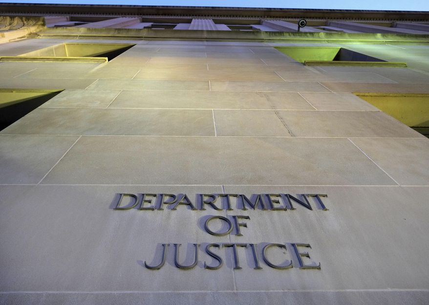 In this May 14, 2013, file photo, the Department of Justice headquarters building in Washington is photographed early in the morning. (AP Photo/J. David Ake, File) **FILE**