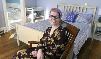 In this Friday, March 8, 2018 photo, Erika Urban sits in one of the rooms she and three other midwives use to provide care at the River Valley Birth Center in St. Peter, Minn. Urban opened the center in 2014. (Pat Christman/The Free Press via AP)
