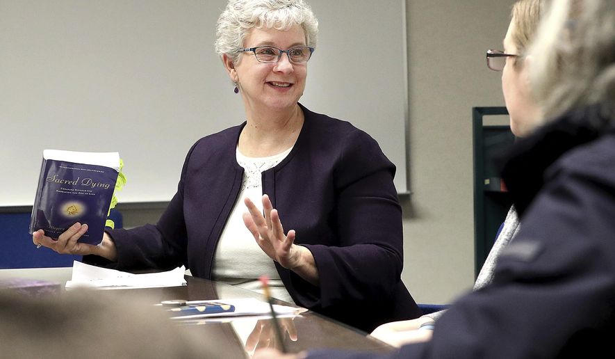 In this March 7, 2018, photo, Dr. Jackie Yeager leads a conversation on the subject of mortality during a &amp;quot;Death Cafe&amp;quot; meeting at the La Crosse Public Library in La Crosse, Wis. Death Cafes offer a confidential, judgment-free and nondenominational environment to openly discuss concepts of mortality. (Erik Daily/La Crosse Tribune via AP)