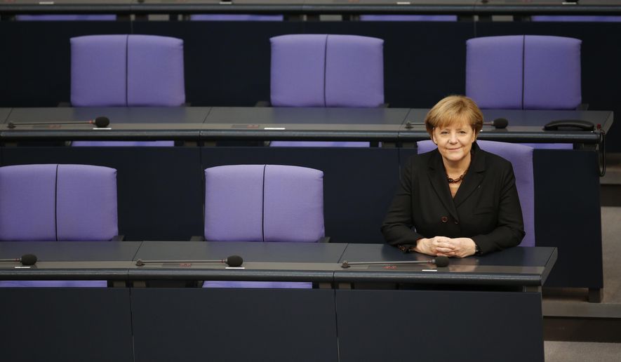 FILE - In this Dec. 17, 2013 file photo German Chancellor Angela Merkel sits smiling at the government bench after being reelected during a meeting of the German federal parliament, Bundestag, in Berlin, Germany. On Wednesday, March 14, 2018 Angela Merkel is set to pledge for the fourth time to dedicate her efforts to Germans’ well-being and &#x27;protect them from harm&#x27;. (AP Photo/Michael Sohn, file)