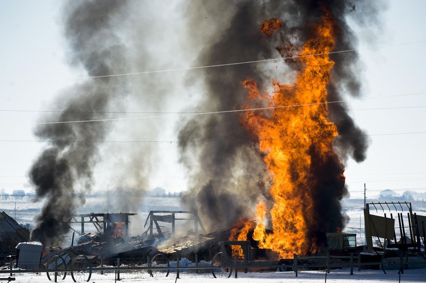 Fires burn after a propane explosion at a residence north of Helena, Mont., on Tuesday, March 13, 2018. A man suffered burns and a garage was destroyed in the incident. (Thom Bridge/Independent Record via AP)