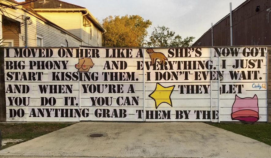 This Nov. 5, 2017 photo provided by Neal Morris shows a mural on his property in New Orleans, La. On Tuesday, March 13, 2018, the American Civil Liberties Union went to court for Morris who says he&#x27;s been ordered to remove the large mural that features infamous Donald Trump quotes from a 2005 &amp;quot;Access Hollywood&amp;quot; recording. A federal court lawsuit says Morris was ordered by the city to remove the mural soon after it was painted in November. (Neal Morris via AP)