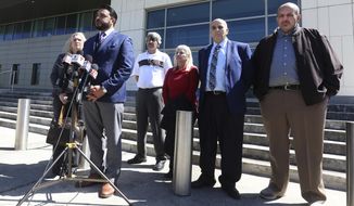 Susan Clary, spokesperson for Noor Salman&#39;s family, Ahmed Bedier, President, United Voices For America, 2nd from left, and the four members of Noor Salman&#39;s family, right, address the media Wednesday, March 14, 2018, outside the Federal courthouse in Orlando, Fla. Salman went on trial Wednesday in Orlando. The 31-year-old is accused of aiding and abetting her husband in his attack on the Pulse nightclub in June of 2016. (Red Huber/Orlando Sentinel via AP)