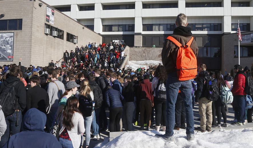 The Central High School student body file out of school as they participate in a student walkout Wednesday, March 14, 2018, in St. Paul, Minn. Students across the country participated in walkouts Wednesday to protest gun violence, one month after the deadly shooting inside a high school in Parkland, Fla. (AP Photo/Jim Mone)