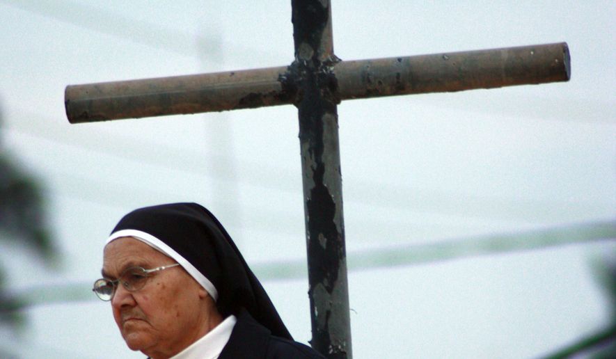 An Iraqi catholic nun is seen before Christmas Eve mass in Mosul, 360 kilometers (225 miles) northwest of Baghdad on Dec. 24, 2009. (Associated Press) **FILE**